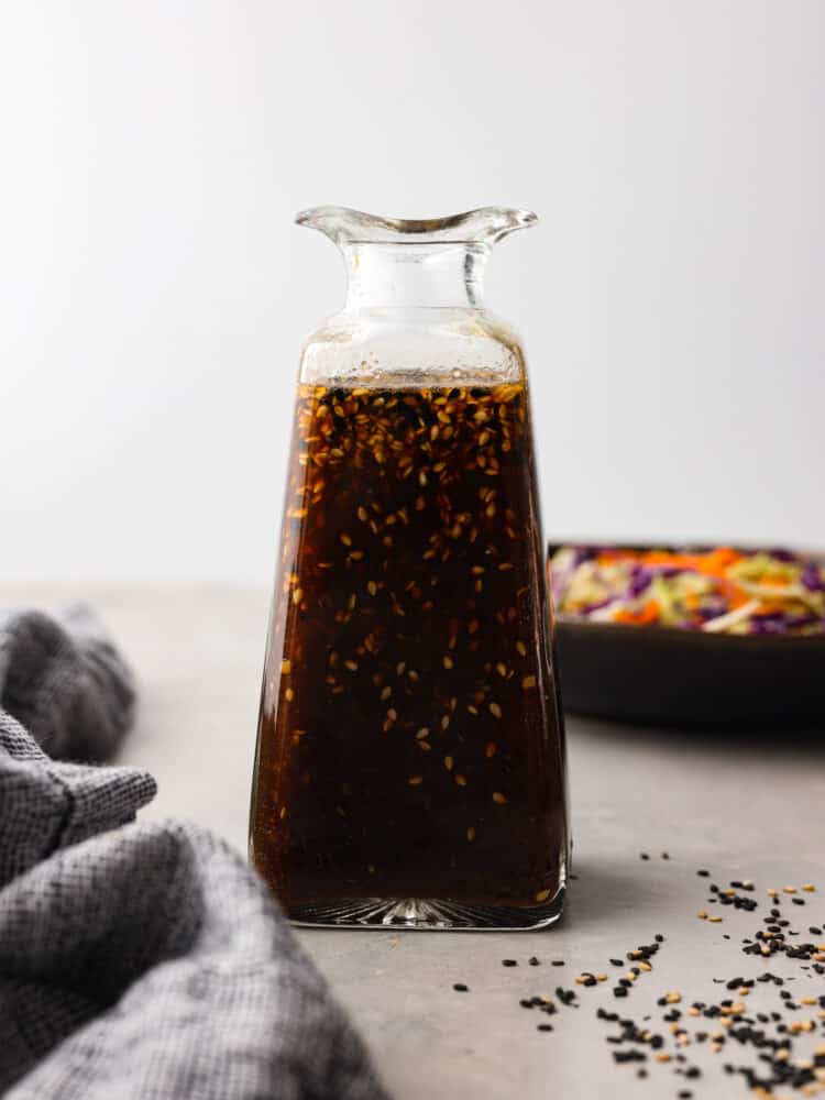 Packed with tangy, savory flavor, and sesame seeds for texture, this homemade Asian salad dressing is the perfect addition to your favorite bowl of greens. It’s made without preservatives and artificial flavors for a dressing you can feel great about using! Hero image of Asian salad dressing in a glass bottle.