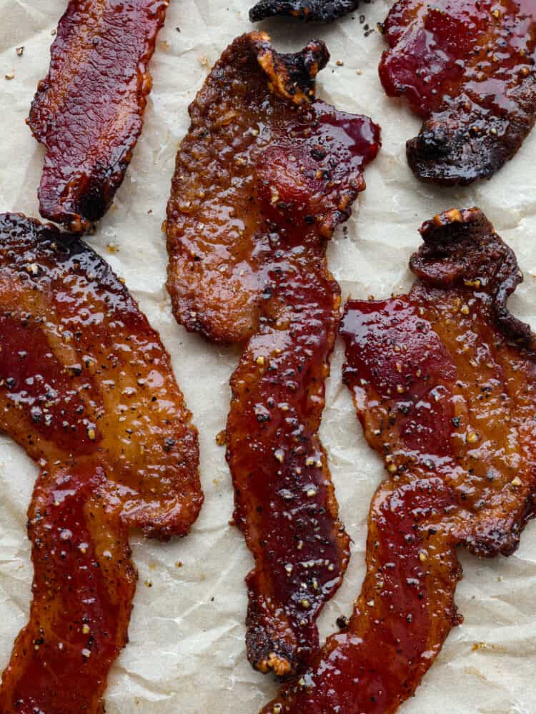 Once you try candied bacon, you wonโt want it any other way. Thick-cut slices of bacon in a caramelized brown sugar coating, topped off with a pinch of black pepper and cayenne - what could be better? Itโs a flavor combination you wonโt be able to stop thinking about. Closeup of candied bacon.