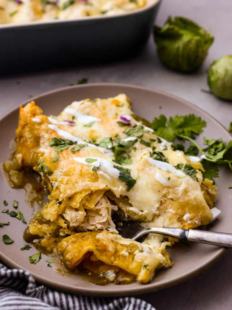 Enchiladas Suizas is a ridiculously delicious Mexican dish that'll make your taste buds go wild! Picture this: juicy shredded chicken wrapped in soft corn tortillas, slathered in a zesty tomatillo sauce, and smothered with creamy sour cream and melty cheese. Taking a bite of enchiladas suizas.