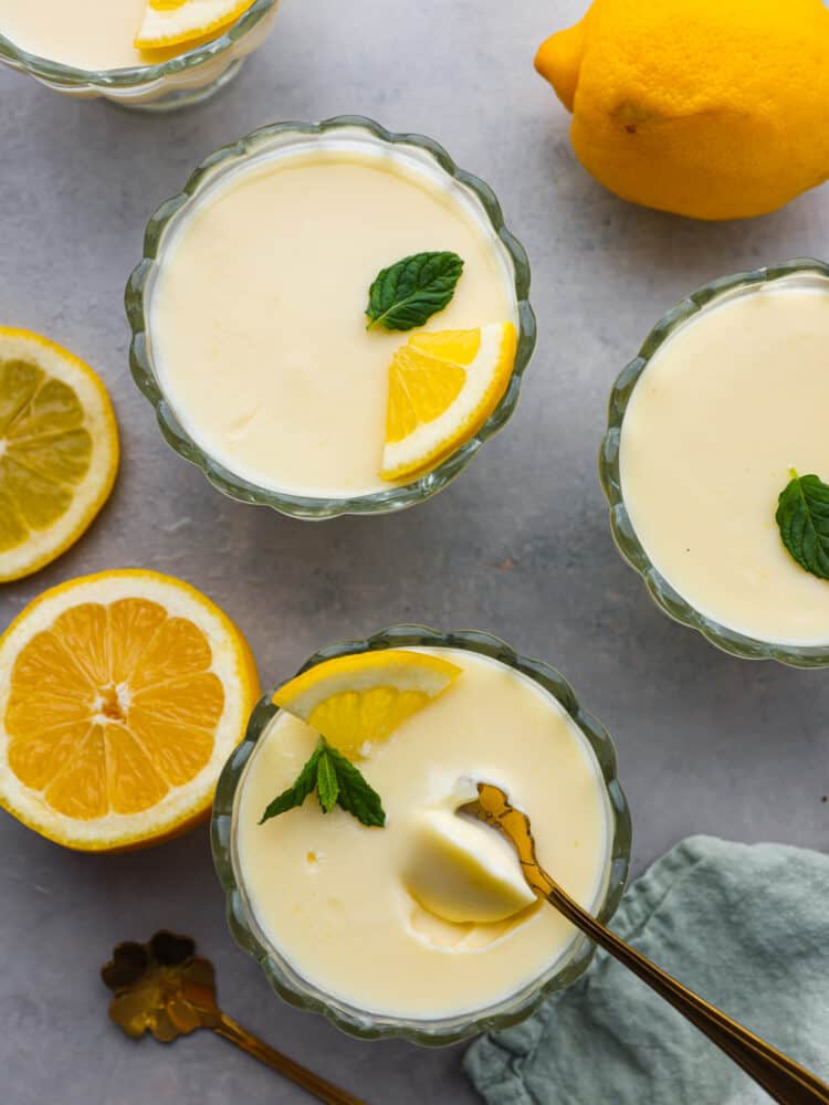 Lemon Posset- Only 5 Ingredients! Top-down view of glass cups filled with a creamy lemon posset filling.