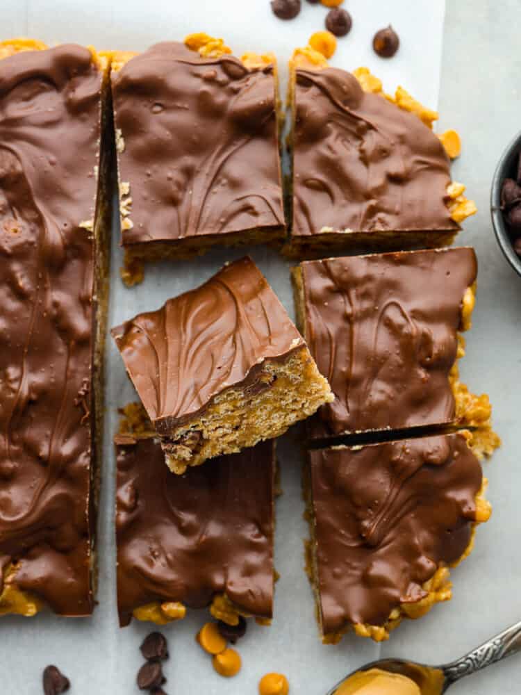 These Special K Bars are a delicious combination of smooth peanut butter, crispy Special K cereal, and a rich chocolate-butterscotch topping. This quick and easy recipe is a sweet treat that will leave you craving more. The top view of Special K bars on some parchment paper.