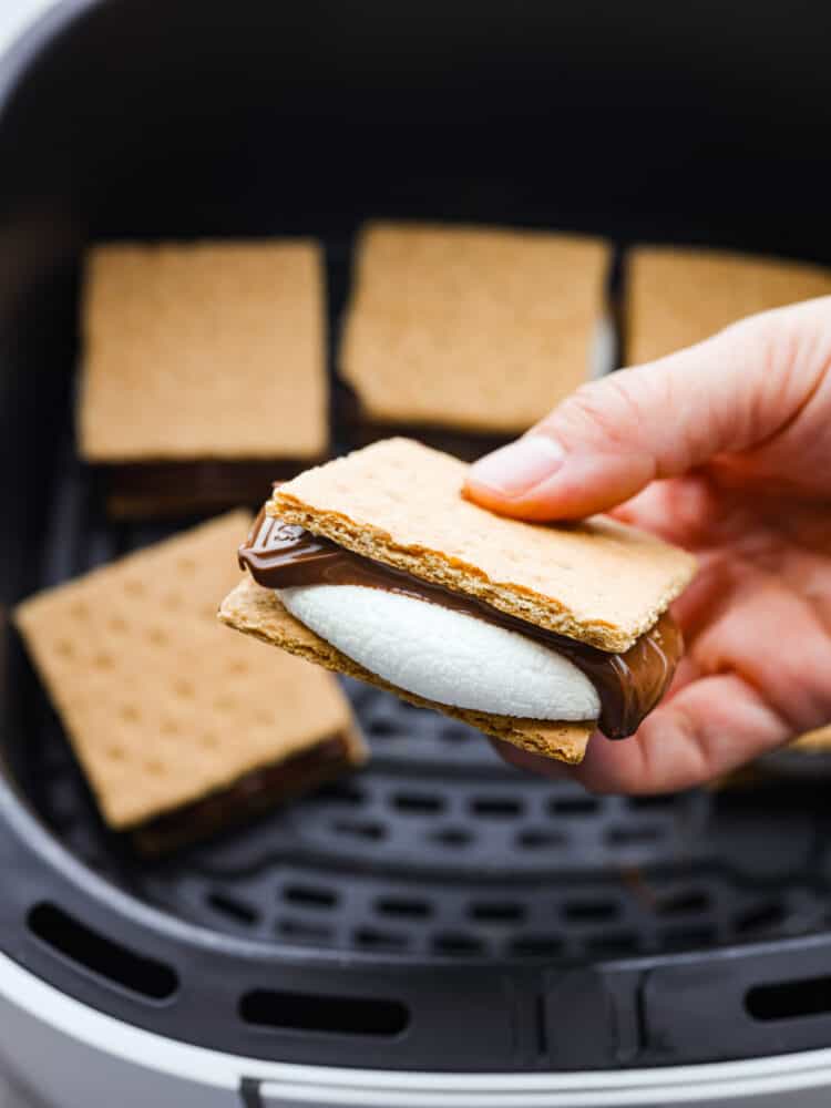 S'mores made easy in the air fryer! In just 7 minutes you'll have the most ooey-gooey air fryer smores, no campfire required! It's a quick and easy recipe you'll want to make all summer long. Picking up an air fryer s’more.
