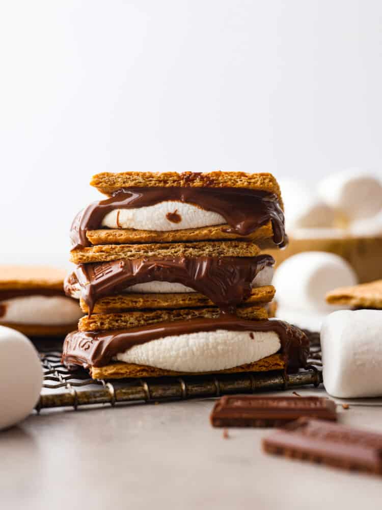 S'mores made easy in the air fryer! In just 7 minutes you'll have the most ooey-gooey air fryer smores, no campfire required! It's a quick and easy recipe you'll want to make all summer long. 3 s’mores stacked on top of each other.