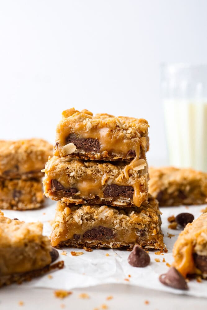 This recipe for Carmelitas is a divine dessert that combines layers of buttery oats, gooey caramel, and rich semisweet chocolate. With a perfect balance of sweetness and texture, these bars are a heavenly treat that will satisfy any sweet tooth. A stack of 3 Carmelitas.