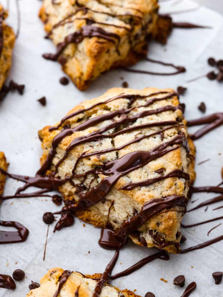 Chocolate chip scones are downright delicious. Theyโre buttery and soft, with pockets of chocolate chips for a melty surprise in each bite. These homemade scones are great for an on-the-go breakfast or an afternoon snack when youโre craving something sweet! Closeup of a chocolate scone.