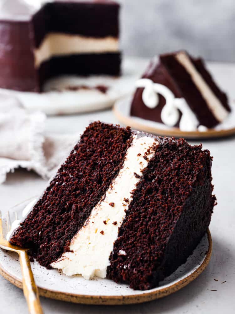 Ding Dong cake is the upgraded version of your favorite snack cakes, featuring a moist chocolate cake with a creamy ermine filling and a mouthwatering chocolate ganache on top! It's a seriously tasty dessert you won't be able to resist! Hero image of a slice of ding dong cake.