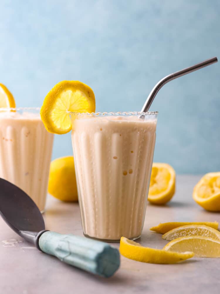 This Copycat Chick Fil A Frosted Lemonade is a delicious and creamy cold drink for the summer. This copycat frozen lemonade is so refreshing and perfect for hot days! Chick fil a frosted lemonade in a glass with a metal straw.