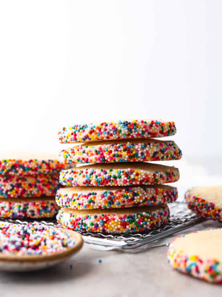 Icebox cookies are the best! They're these yummy treats made with butter, sugar, and vanilla that get even better when you chill the dough before baking. They're crispy on the outside and soft and tender on the inside. You'll be hooked after the first bite! 5 cookies stacked on top of each other.
