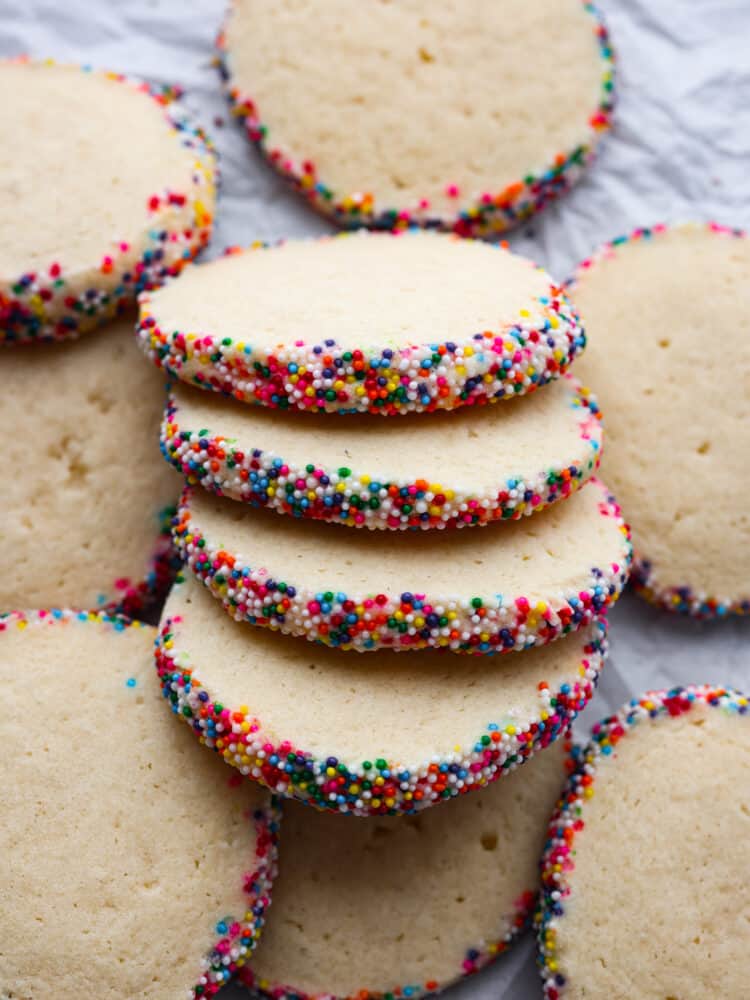Icebox cookies are the best! They're these yummy treats made with butter, sugar, and vanilla that get even better when you chill the dough before baking. They're crispy on the outside and soft and tender on the inside. You'll be hooked after the first bite! Top-down view of sliced icebox cookies.