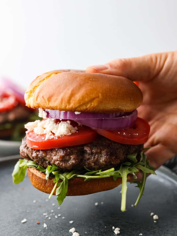 Make these amazing lamb burgers to add a Greek twist to your next summer barbecue! Picking up a burger.