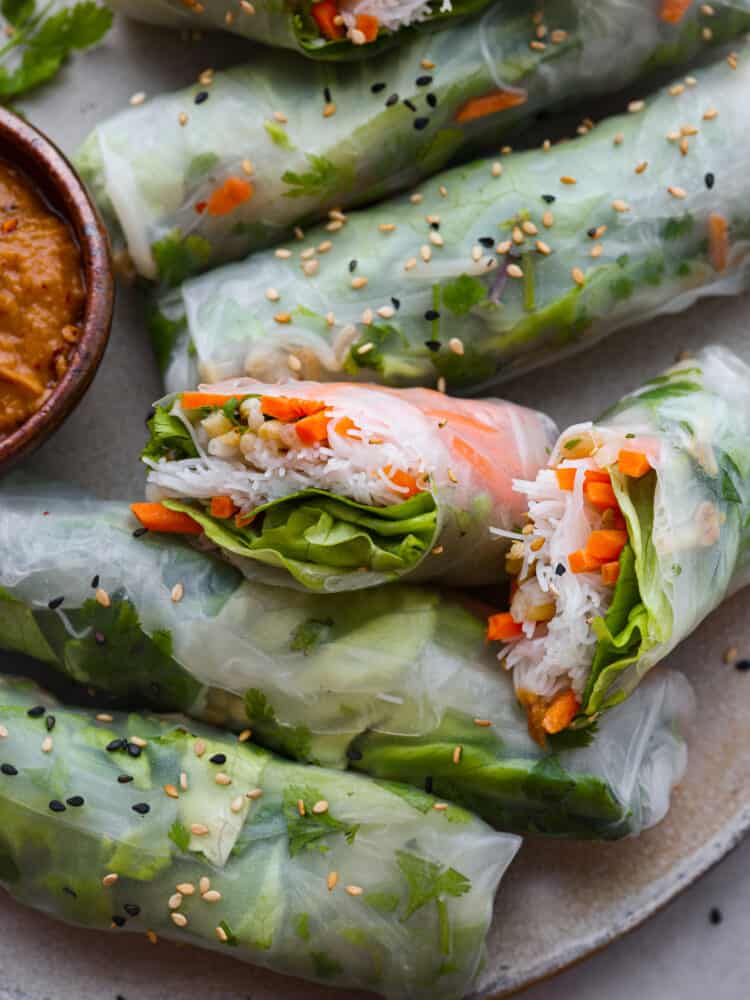 If you're wanting a light and delicious snack, look no further than these Vietnamese summer rolls! They're packed with fresh, crisp veggies and perfect for dipping in your favorite sauces. Closeup of summer rolls.