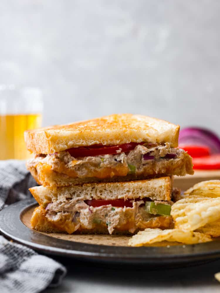 Tuna melts are the ultimate sandwich with a flavorful fish mixture, melty cheddar cheese, and freshly sliced tomatoes all melted together in a skillet on crispy, golden bread. So easy to make and delicious, this sandwich will literally melt in your mouth!