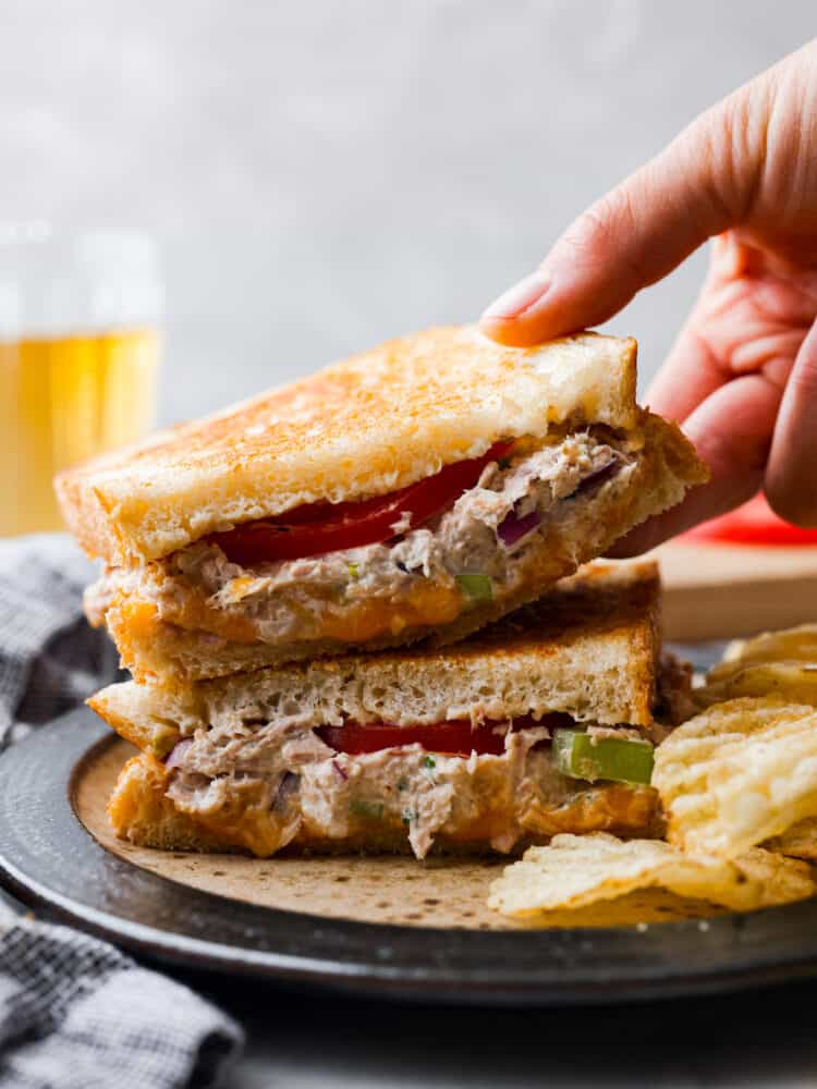 Tuna melts are the ultimate sandwich with a flavorful fish mixture, melty cheddar cheese, and freshly sliced tomatoes all melted together in a skillet on crispy, golden bread. So easy to make and delicious, this sandwich will literally melt in your mouth!