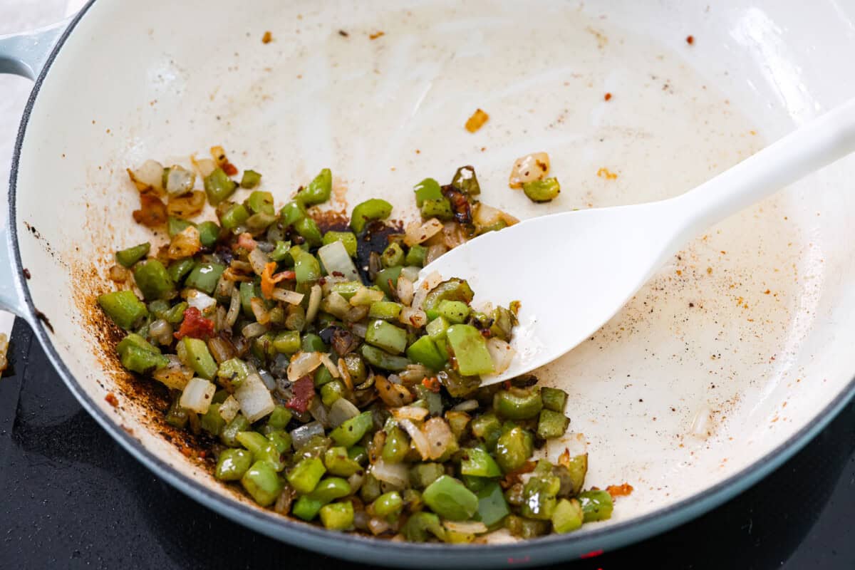 These World's Best Baked Beans will be the last recipe you will ever make! This easy recipe is the perfect side to a potluck and a tried and true family recipe that your family will go crazy over! Second photo of the beans and onions cooking.