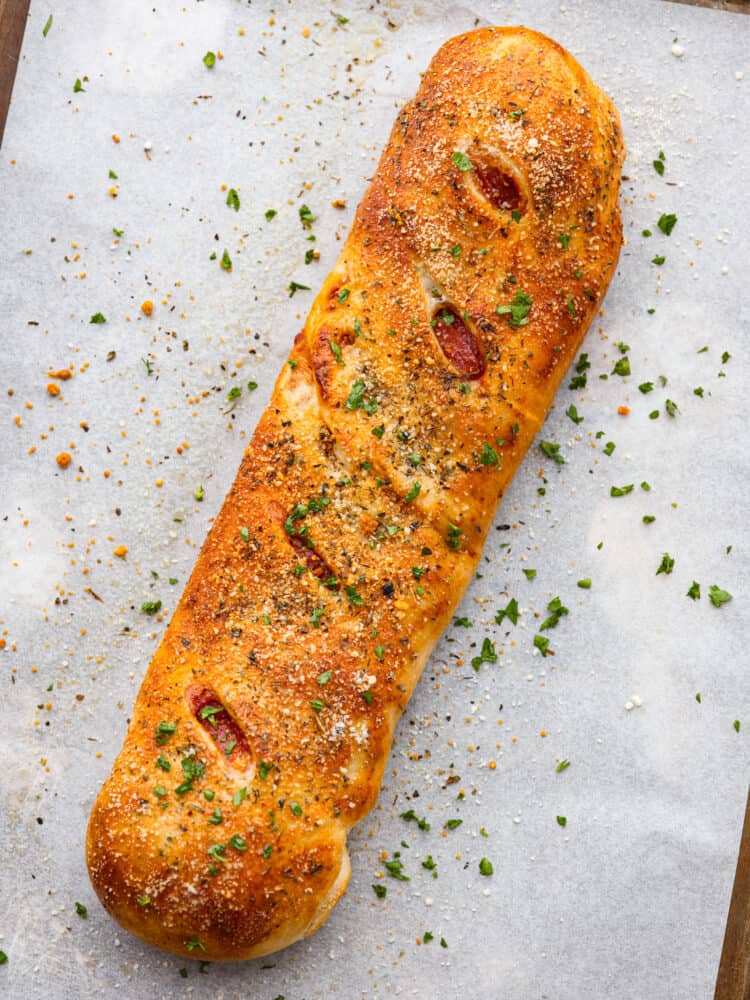 This quick and easy Stromboli gets loaded with Italian salami, pepperoni, pizza sauce and cheese. It's so quick, easy and delicious you will want to make it again and again! A whole cooked stromboli.