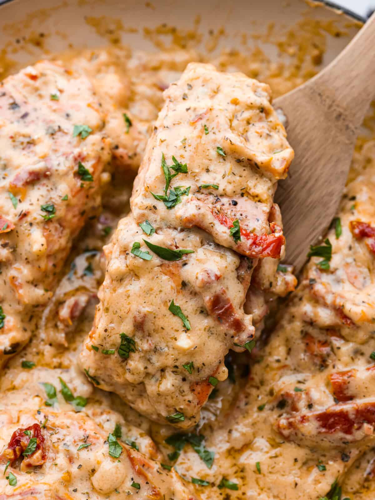 Salmon so good, it will have everyone falling in love! Marry Me Salmon is soft and flaky, smothered in a buttery, creamy sun-dried tomato sauce. Trust me, itโs one of the best dishes youโll ever make! Picking up a piece of salmon.