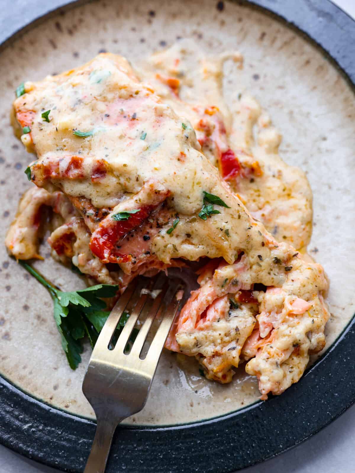 Salmon so good, it will have everyone falling in love! Marry Me Salmon is soft and flaky, smothered in a buttery, creamy sun-dried tomato sauce. Trust me, itโs one of the best dishes youโll ever make! Taking a bite of creamy Tuscan salmon.