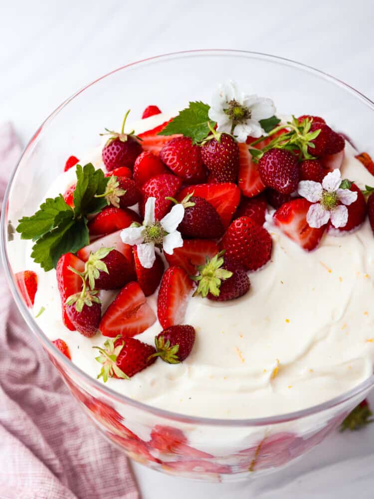 Get ready to dig into this amazing strawberry trifle! Layers of juicy strawberries, creamy cheesecake, and fluffy pound cake come together to create the ultimate summer dessert! Top-down view of strawberry trifle.