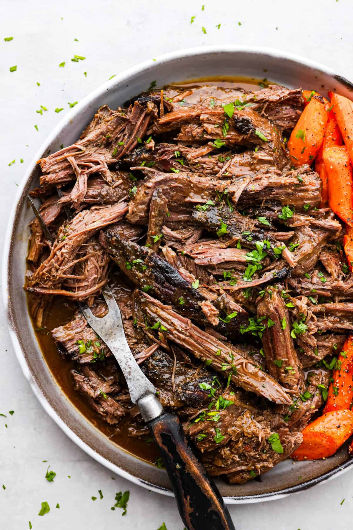 This 3 packet roast is my go-to for an easy but delicious Sunday dinner. Add brown gravy, Italian dressing, and ranch dressing powders to a slow cooker with your beef and then let it work its magic! It creates an ultra-tender, flavorful roast youโll love coming home to at the end of the day. Top-down view of the shredded beef.