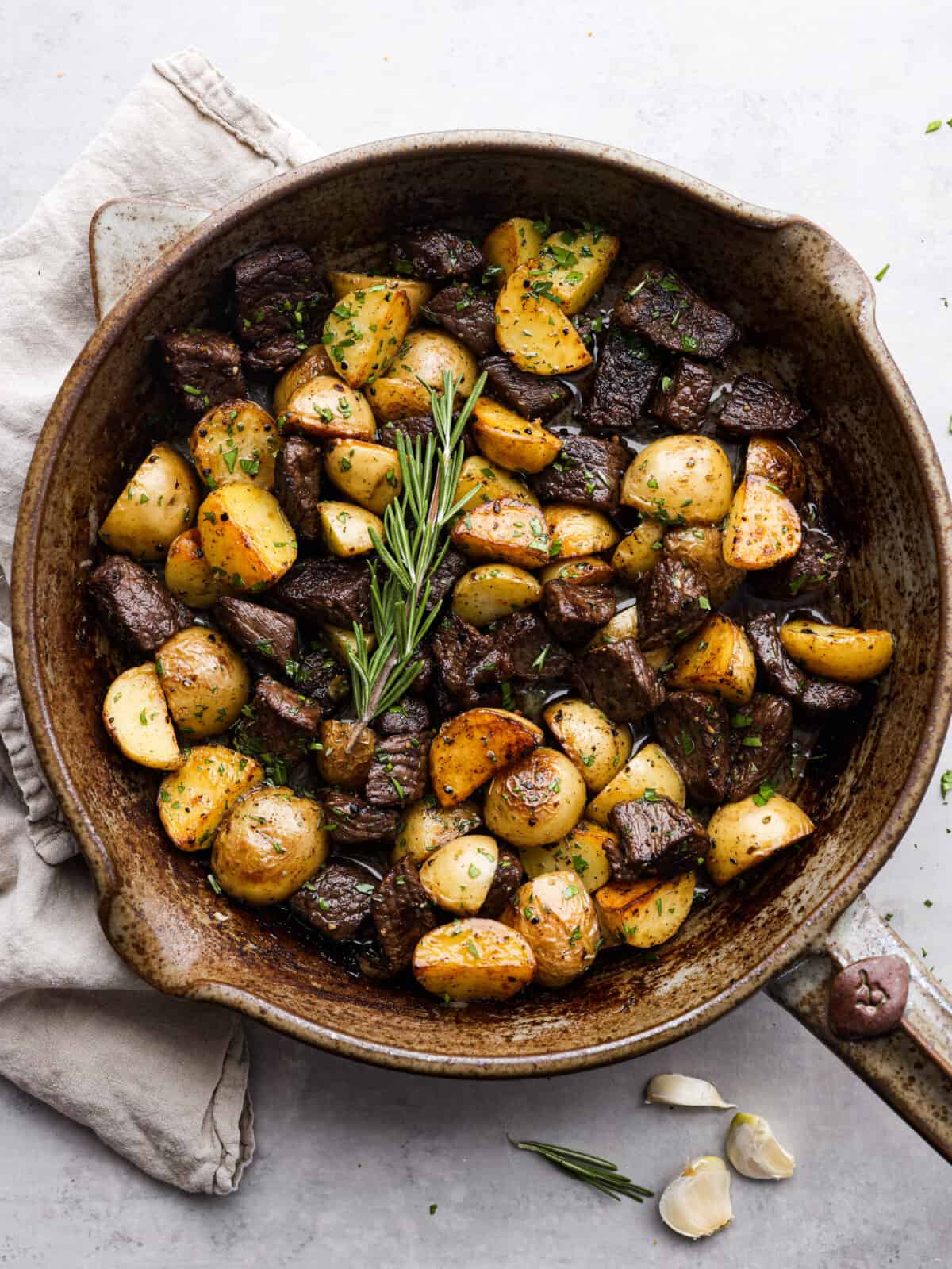 Get ready to obsess! These Garlic Butter Herb Steak Bites with Potatoes are juicy, buttery, and downright irresistible. Easy to make, crazy delicious, and pure comfort in every bite! Garlic Butter Herb Steak Bites with Potatoes in a skillet.