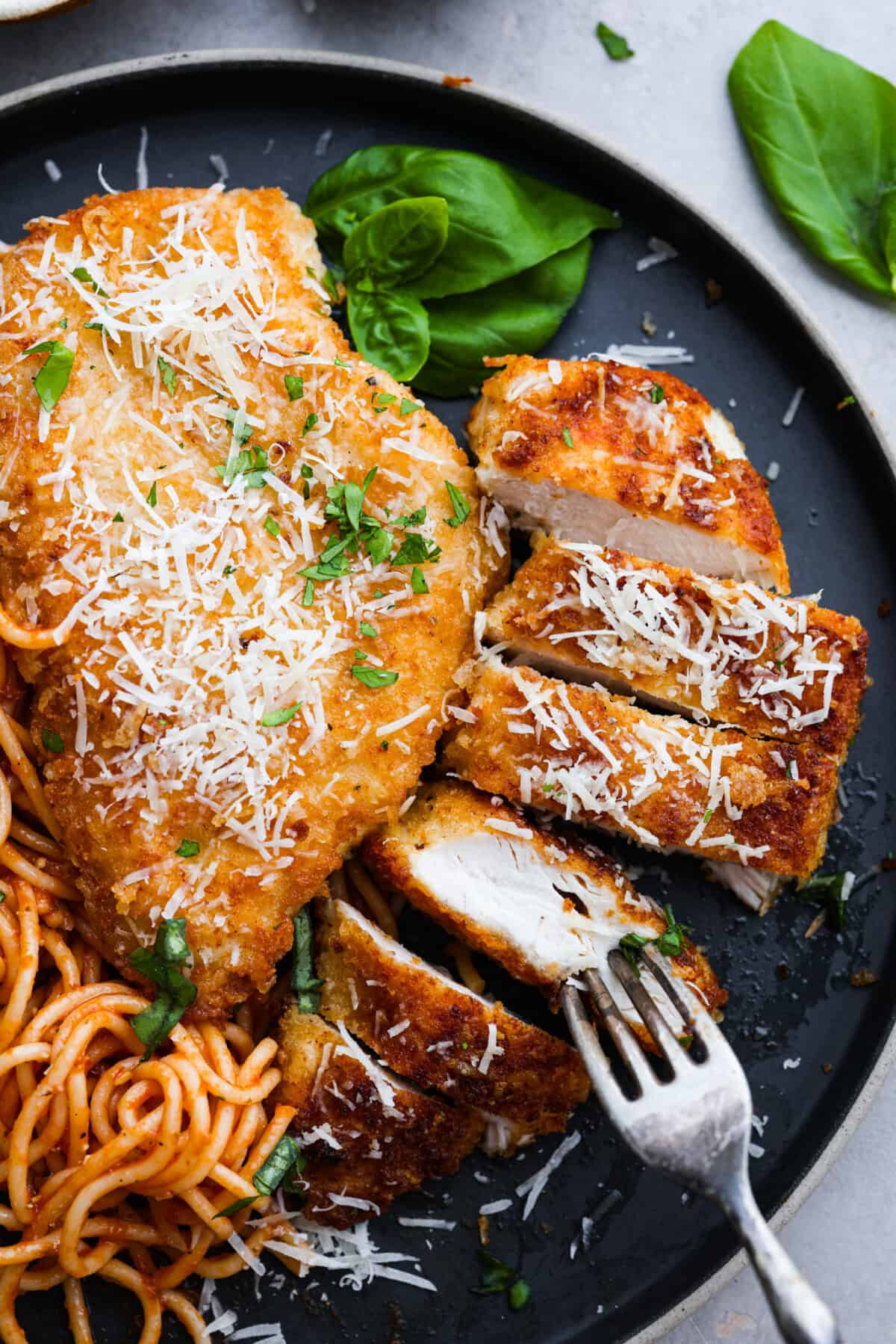 Romano-crusted chicken filets served with tangy marinara and spaghetti noodles. Chicken Romano is golden, crispy, flavorful, and sure to be your family's new favorite meal. 2 chicken cutlets, one cut into slices.