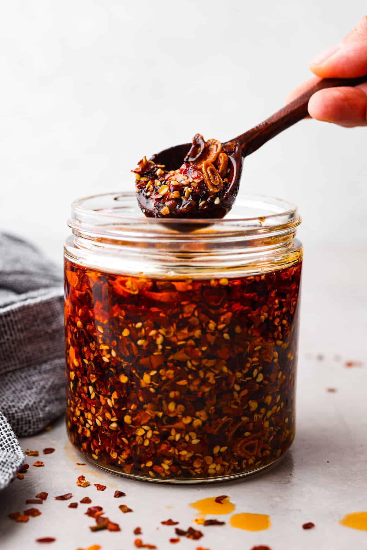 Chili crisp is the secret ingredient every kitchen needs to spice up your dishes effortlessly. It's a mix of crispy shallots, garlic, ginger, fiery chili flakes and sesame seeds that will add the best flavor to any dish! A jar filled with chili crisp.