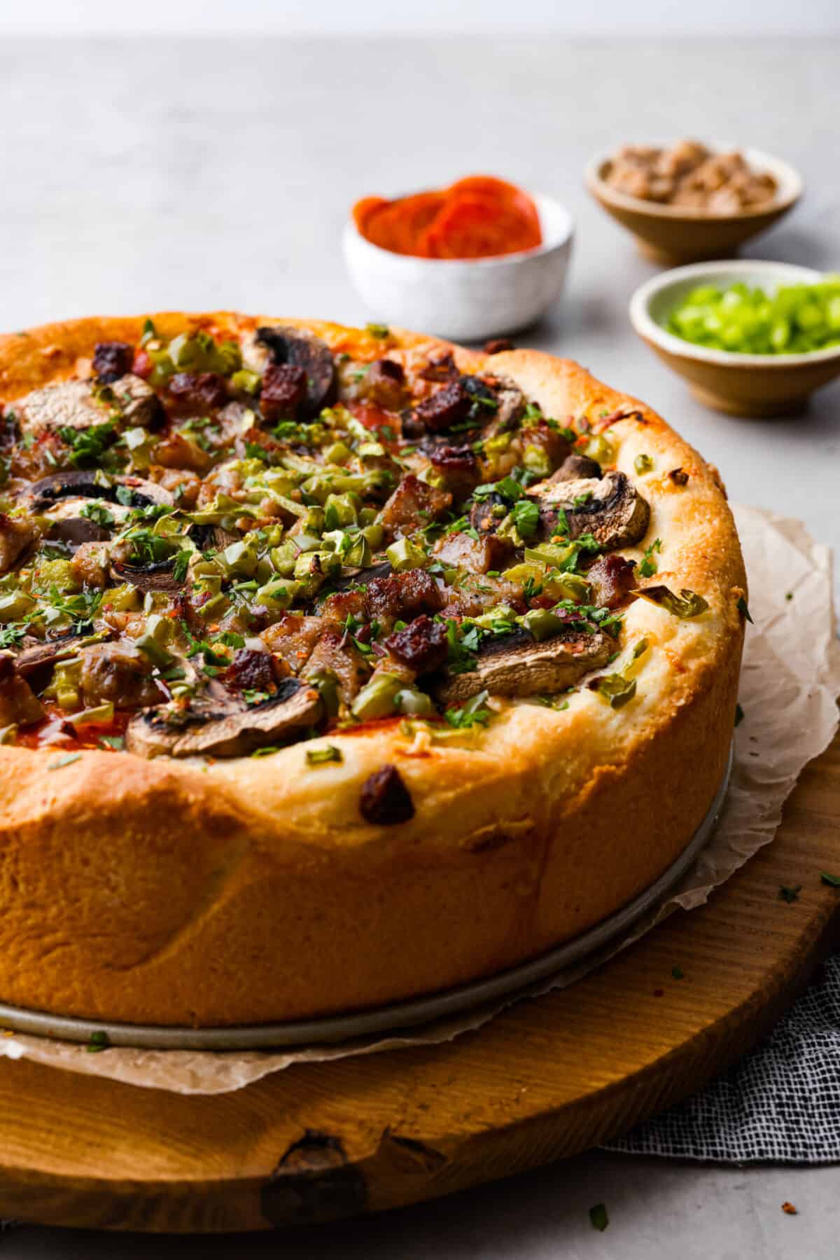 Authentic Chicago-style deep dish pizza! A thick, crispy and flaky crust topped with an easy homemade marinara sauce and shredded mozzarella cheese! It's comfort food at its finest and something the whole family will love. Hero image of a full deep dish pizza.