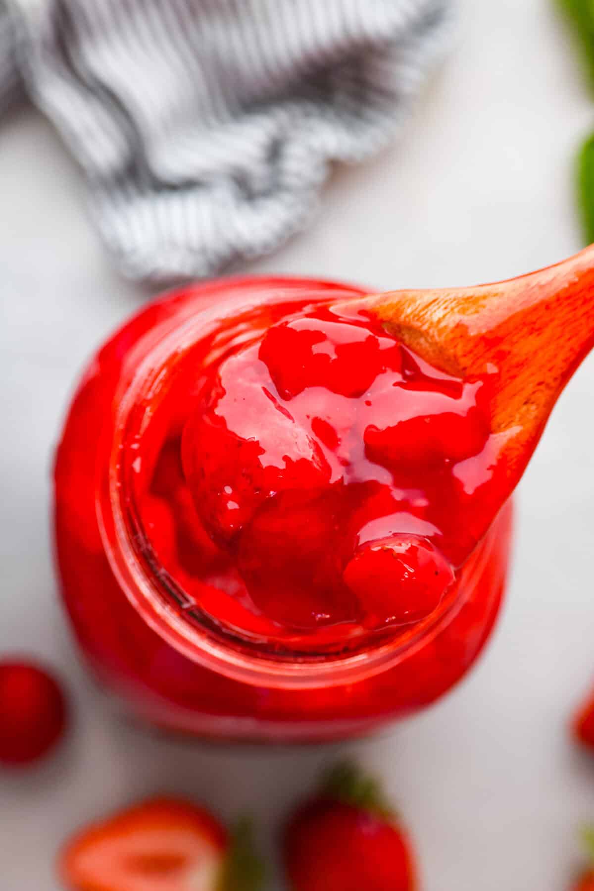 This strawberry pie filling recipe is perfect for anyone who loves a sweet and tangy treat. With easy-to-follow steps and simple ingredients, you'll have a quart of delicious filling ready to enjoy in no time. The top view of strawberry pie filling in a jar.