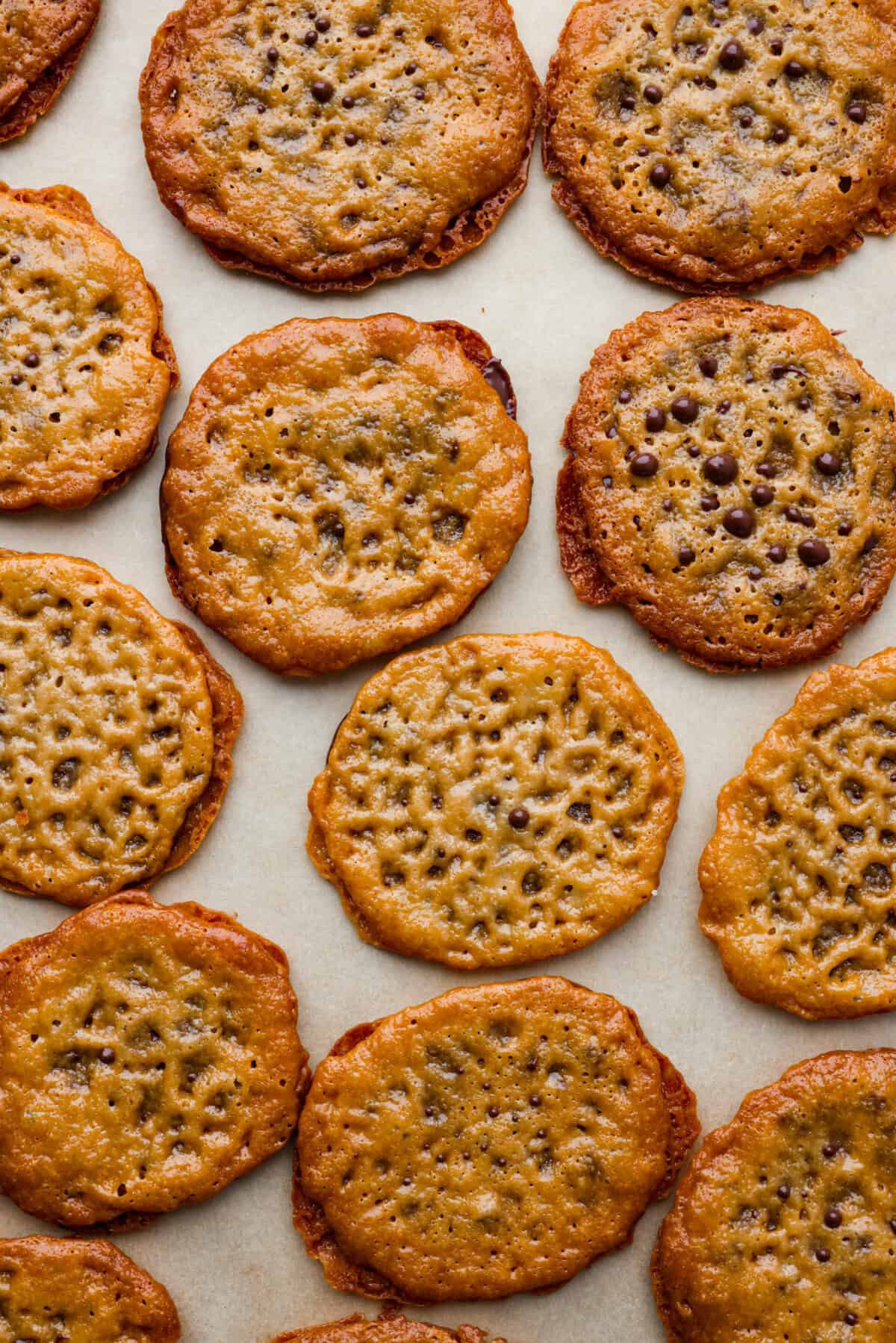 It doesn't get much better than crispy, caramelized cookies with a melted chocolate filling! These lace cookies are super easy to make and just what you need to satisfy your sweet tooth. Top-down view of lace cookies.