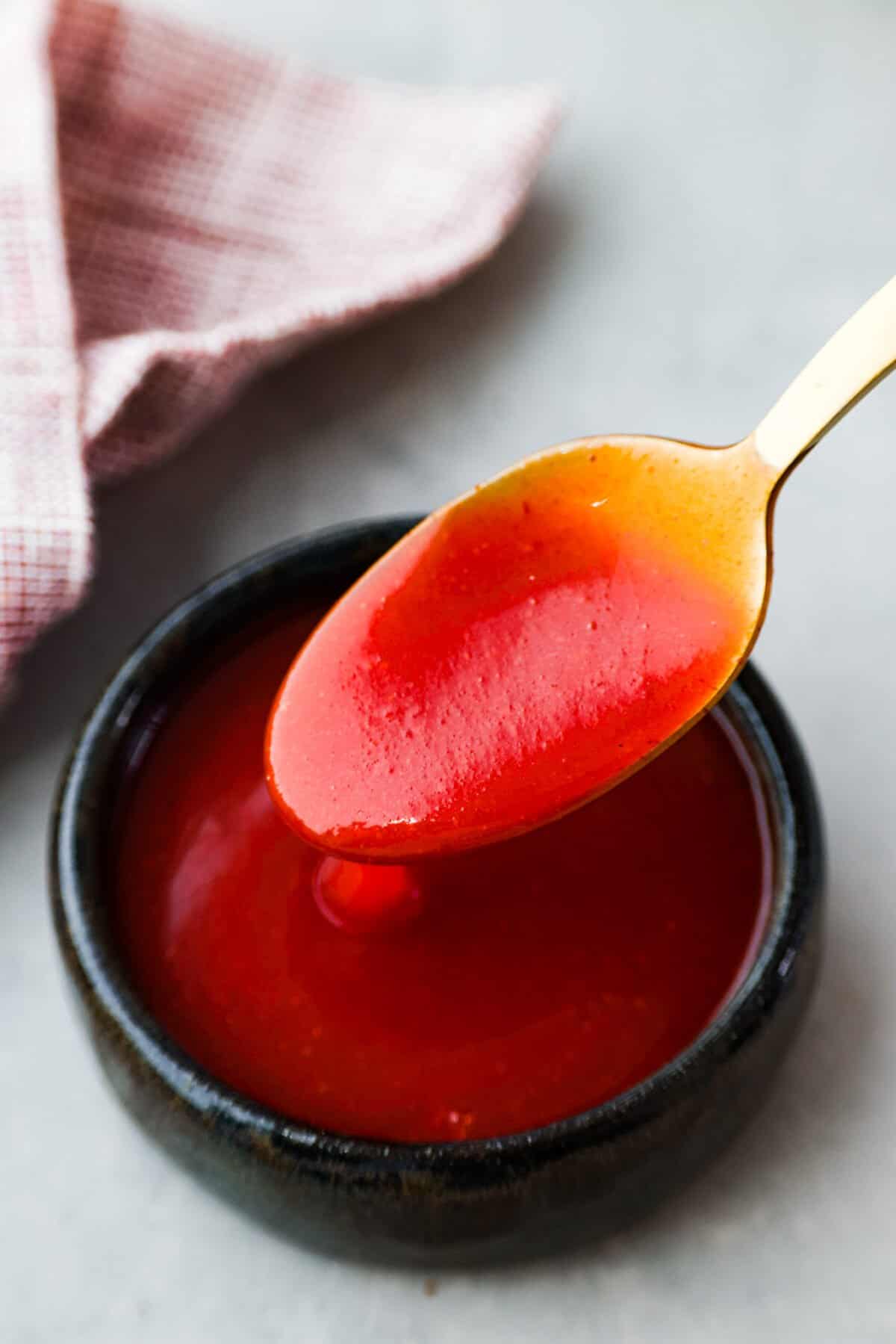 This copycat Chick-fil-A Polynesian sauce has the best kick of flavor! Itโs tangy, zesty, and sweet all at once. Grab some nuggets and get dipping! Closeup of Polynesian sauce.