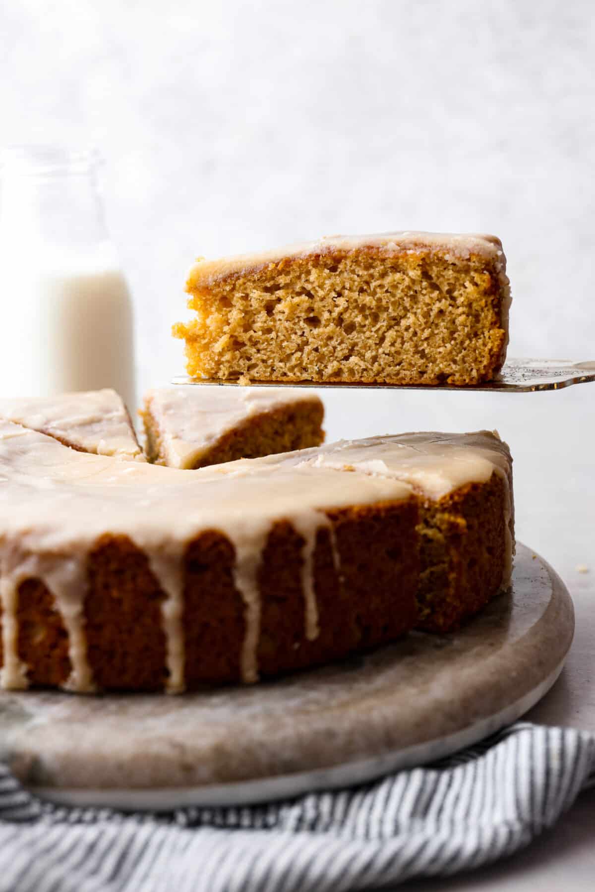 Comforting and delicious with an extra moist crumb, this Buttermilk Cake is the perfect dessert for any occasion!ย To make it really decadent, finish it off with an absolutely irresistible brown sugar vanilla glaze. Serve this at your next family gathering or potluck and watch the rave reviews come pouring in! A slice of buttermilk cake being served with a metal spatula.