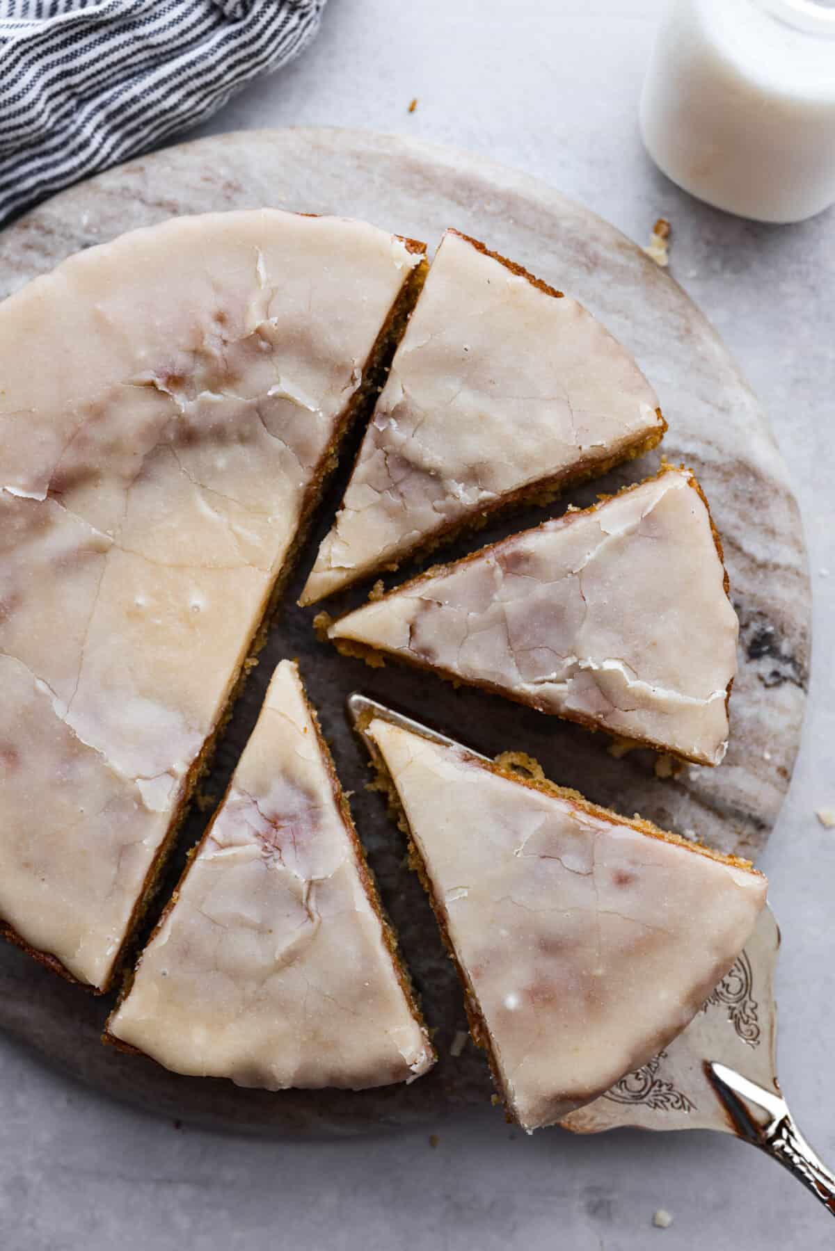Comforting and delicious with an extra moist crumb, this Buttermilk Cake is the perfect dessert for any occasion!ย To make it really decadent, finish it off with an absolutely irresistible brown sugar vanilla glaze. Serve this at your next family gathering or potluck and watch the rave reviews come pouring in! Top-down view of buttermilk cake, cut into slices.