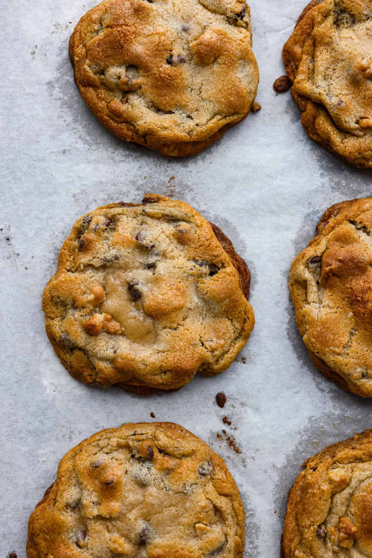 New York City's most beloved cookie, the Levain Cookie is perfectly crisp around the edges with an irresistible thick and gooey center. Top-down view of a baked Levain cookie.