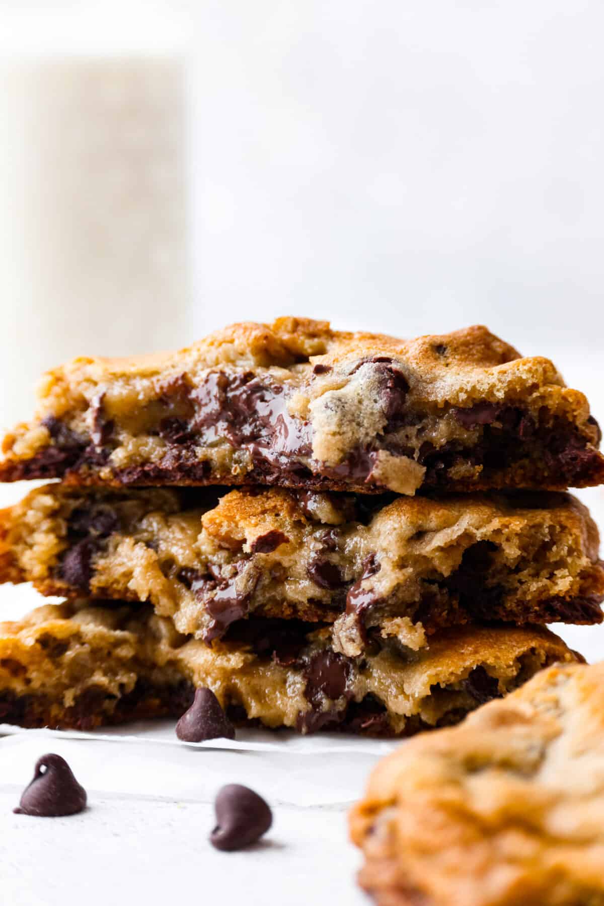 New York City's most beloved cookie, the Levain Cookie is perfectly crisp around the edges with an irresistible thick and gooey center. 3 halves of copycat Levain Cookies stacked on top of each other.