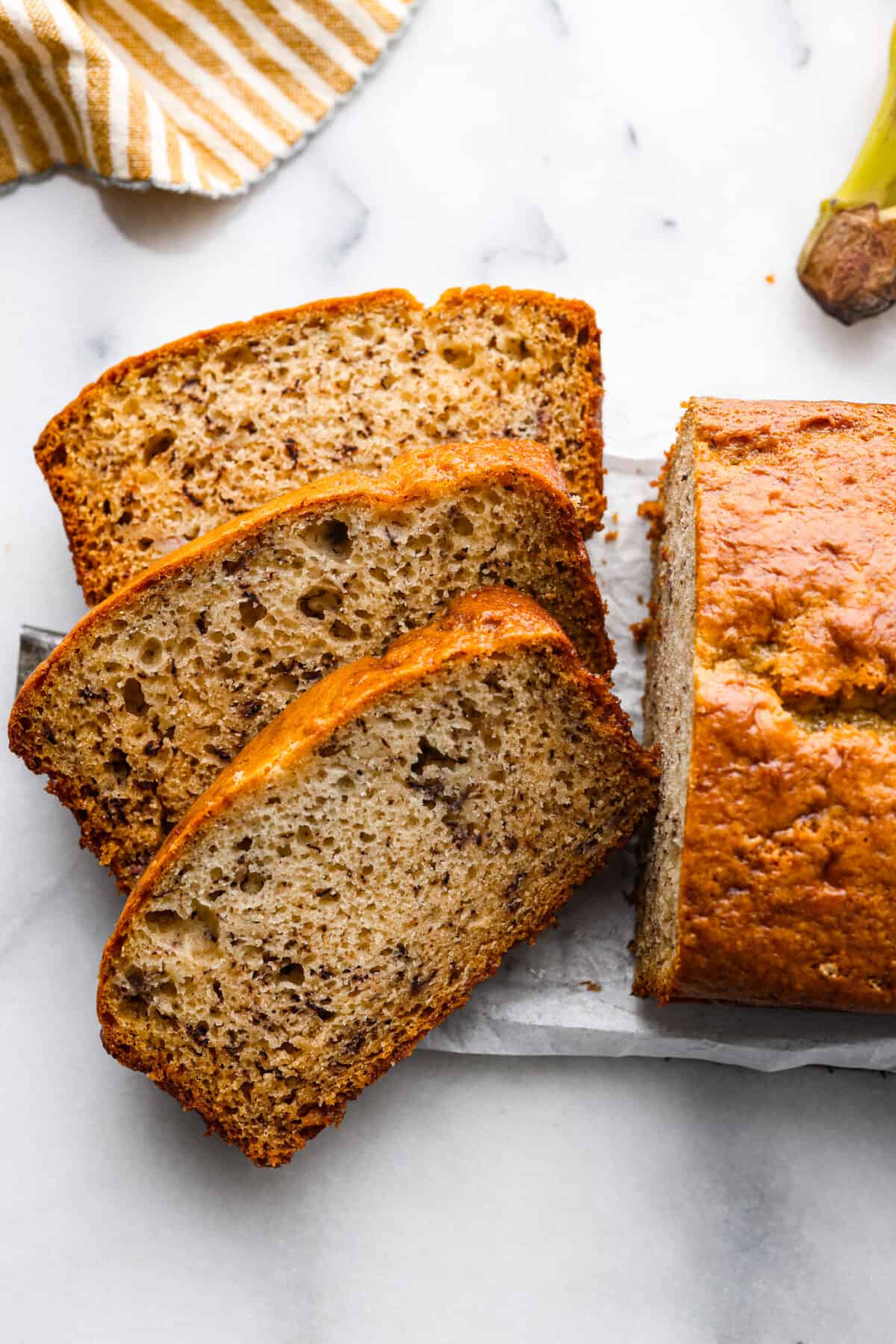 Make your homemade banana bread even more tender and delicious by adding in sour cream! This recipe is the best youโll try, and you wonโt be able to stop at one piece! Sour cream banana bread, cut into 3 slices.