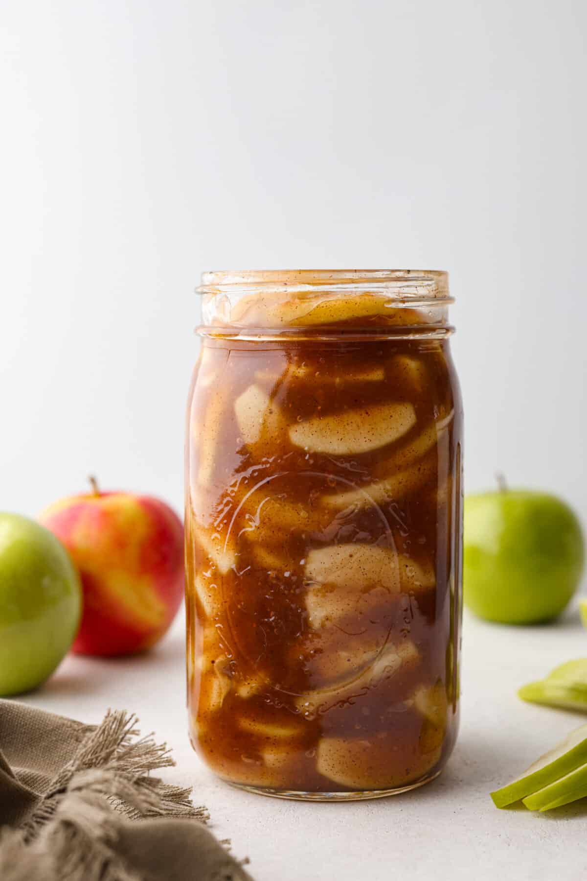 Make your Thanksgiving pies taste even better this year with some fresh apple pie filling! It has the perfect, glossy consistency and tastes absolutely delicious with the added cinnamon and nutmeg. The perfect substitute for canned apple pie filling. Plus, it's easy to freeze for later. A mason jar filled with apple pie filling.