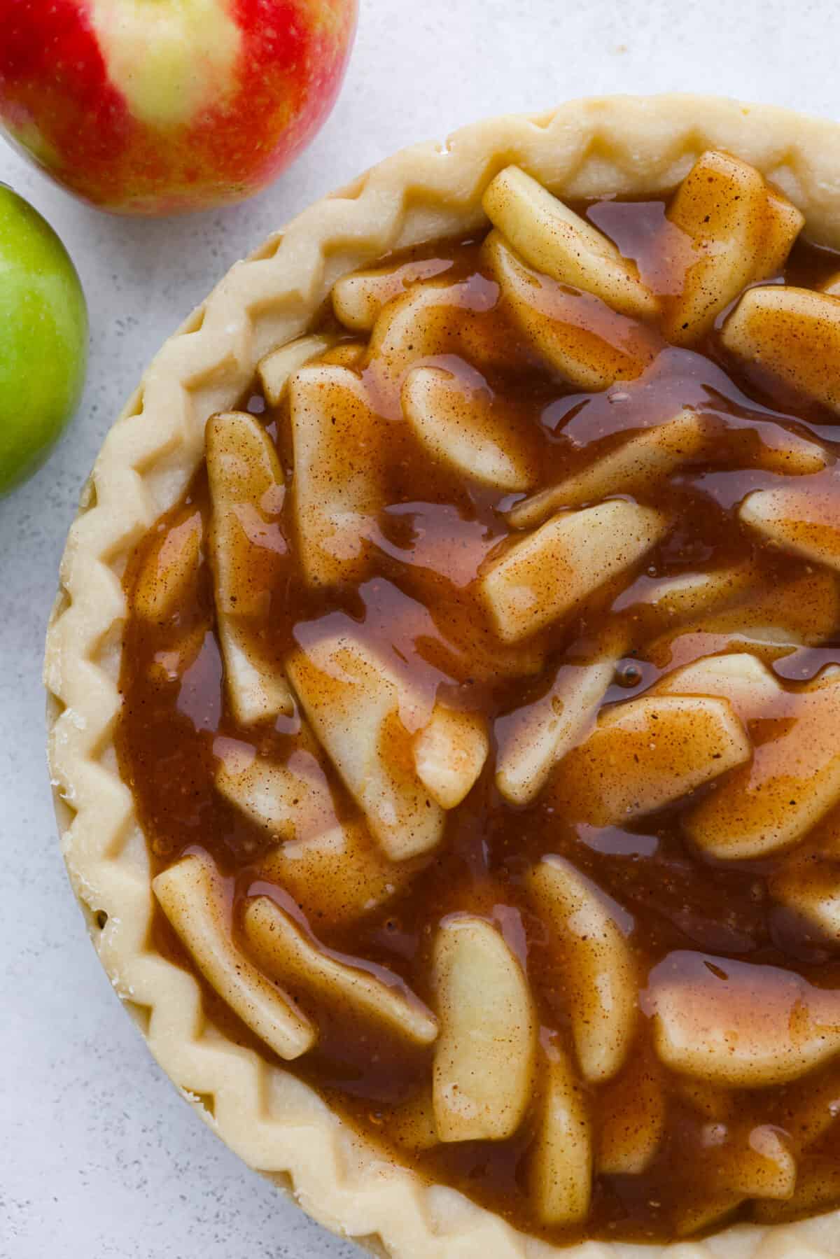 Make your Thanksgiving pies taste even better this year with some fresh apple pie filling! It has the perfect, glossy consistency and tastes absolutely delicious with the added cinnamon and nutmeg. The perfect substitute for canned apple pie filling. Plus, it's easy to freeze for later. Apple filling added to a pie crust.