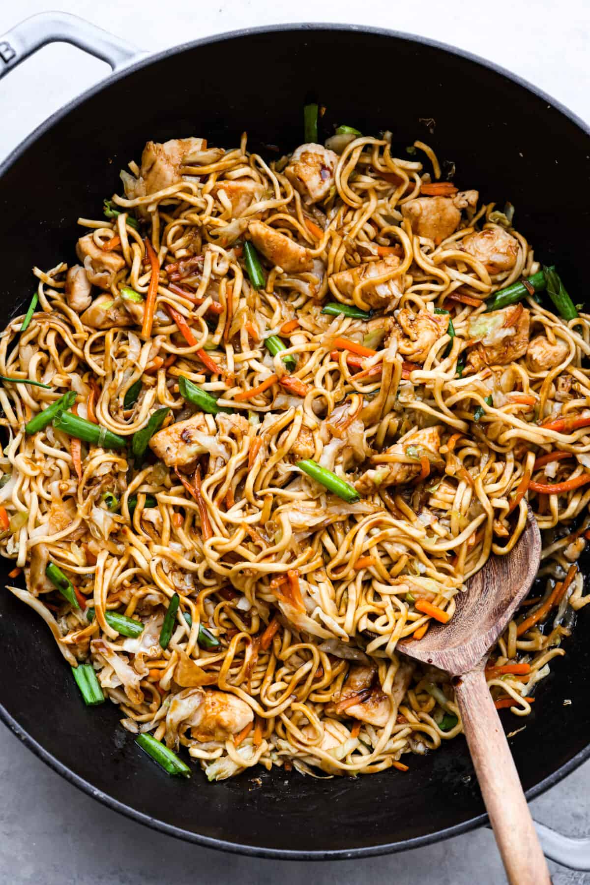 This delicious Chicken Chow Mein is perfect for a quick and easy weeknight meal that your entire family will love! It's made with fresh veggies, noodles, and sautรฉed chicken, tossed in a simple, savory glaze. A skillet filled with chow mein.
