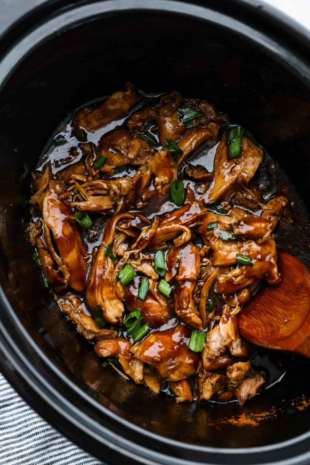 Tender and juicy chicken thighs simmered in a brown sugar bourbon sauce all day long. Your family will love this melt-in-your-mouth crockpot bourbon chicken. A classic New Orleans recipe made easy in the crockpot!