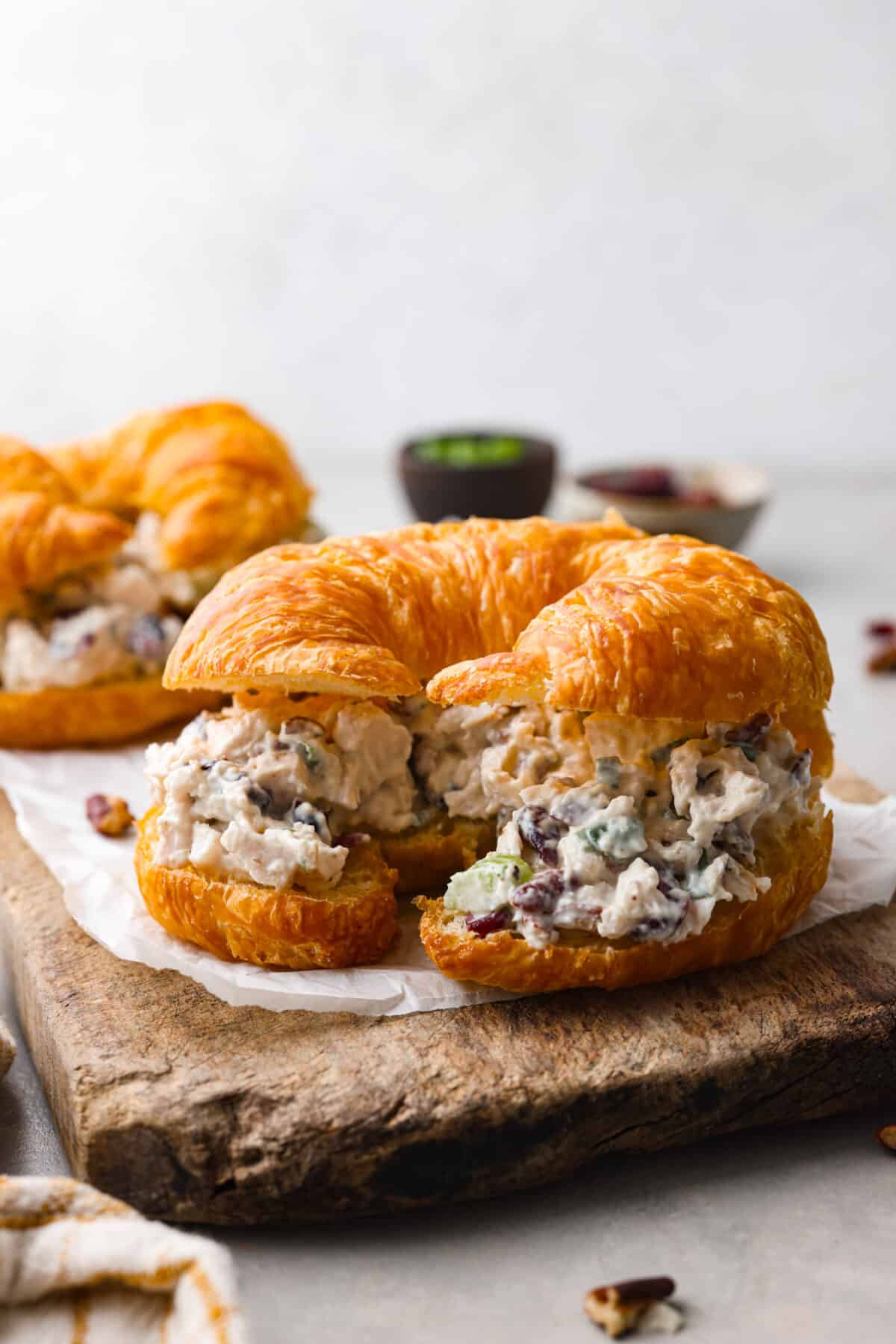 This Turkey Salad is a fresh, satisfying dish loaded with fruit, veggies, and nuts. It comes together quickly and is the perfect way to use up leftover turkey from Thanksgiving! A croissant filled with turkey salad.