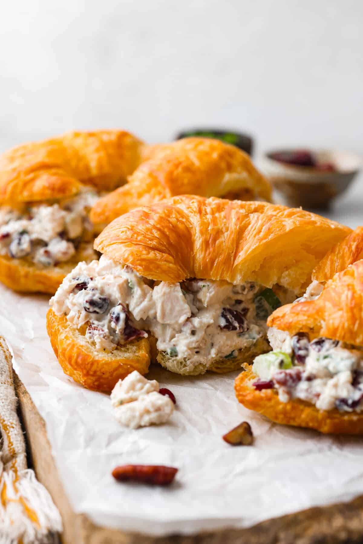 This Turkey Salad is a fresh, satisfying dish loaded with fruit, veggies, and nuts. It comes together quickly and is the perfect way to use up leftover turkey from Thanksgiving! Turkey salad inside of a croissant.