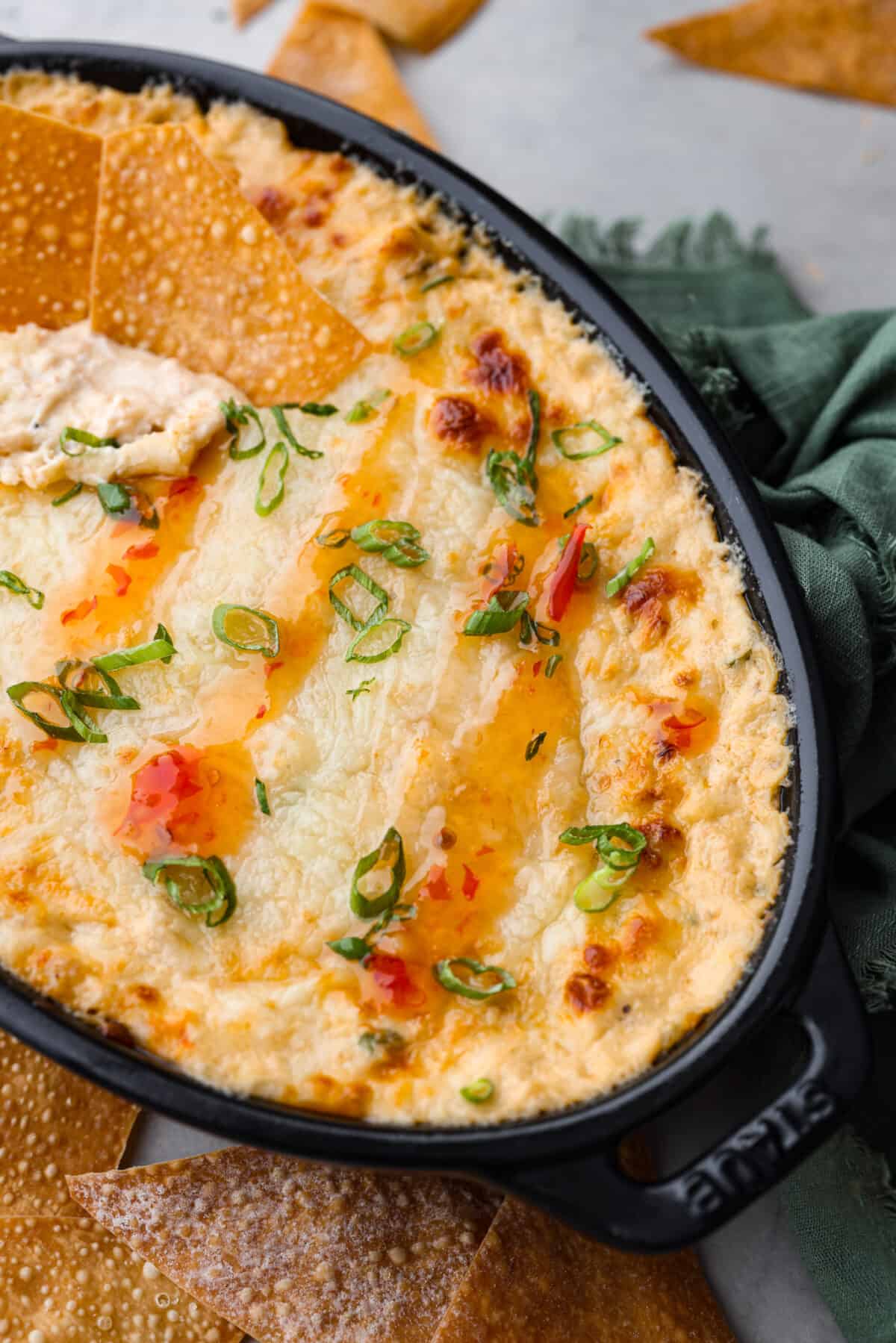 We are obsessed with this crab rangoon dip! It’s hot, creamy, cheesy and packed with crab and major flavor. It's sure to become your go-to appetizer when you really want to impress! Closeup of crab rangoon dip.
