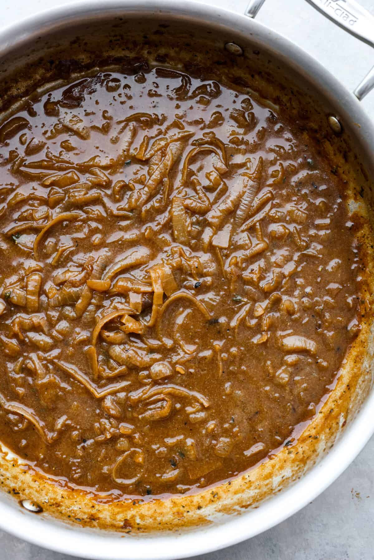 French Onion Soup is such a classic and SO easy to make! Onions are slowly caramelized until soft and sweet, simmered with beef broth, thyme, sherry, and white wine. It's topped with a crispy crouton, loads of shredded gruyere cheese and broiled into a crispy, cheesy oblivion. So good! Onions caramelizing in a pot.