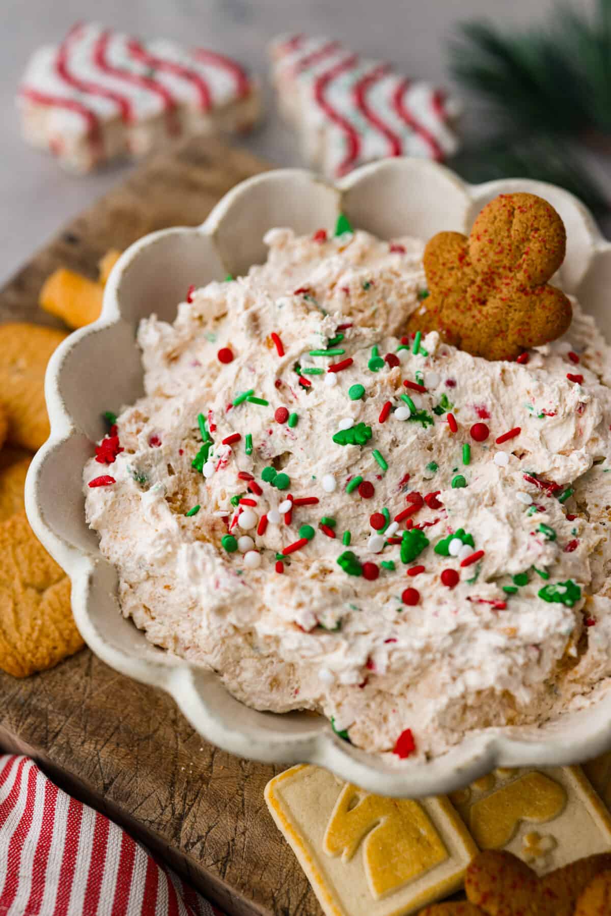 A favorite holiday treat turned into a creamy dip to share! This Little Debbie Christmas tree dip is rich, sweet, and perfect for dipping your favorite cookies in. Closeup of Little Debbie Christmas Tree Dip with a gingerbread cookie stuck in it.