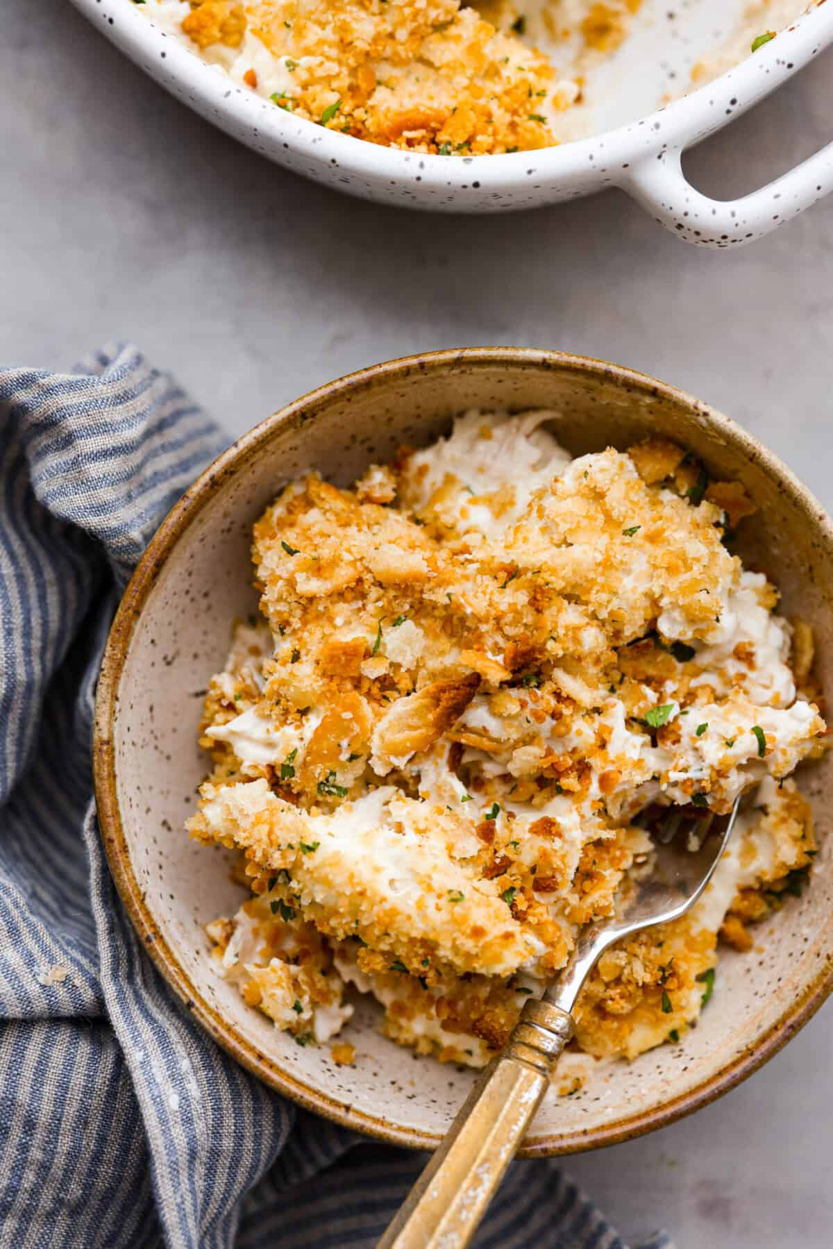 Million Dollar Chicken casserole is both delicious and easy to make. The combination of tender chicken, creamy sauce, and crispy Ritz cracker topping is irresistible. The flavor and texture is so good, you'll think it costs a million dollars! Overhead shot of plated million dollar chicken casserole.