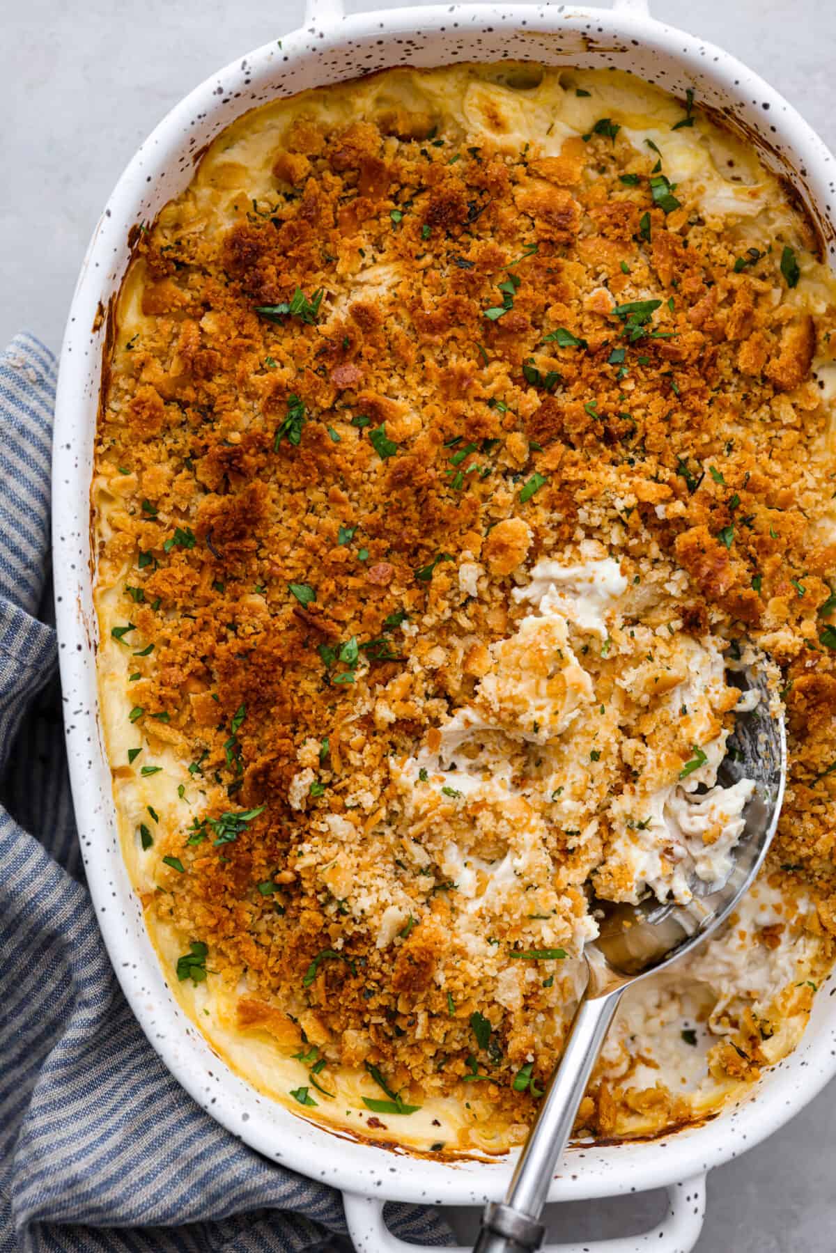 Million Dollar Chicken casserole is both delicious and easy to make. The combination of tender chicken, creamy sauce, and crispy Ritz cracker topping is irresistible. The flavor and texture is so good, you'll think it costs a million dollars! Overhead shot of million dollar chicken casserole.