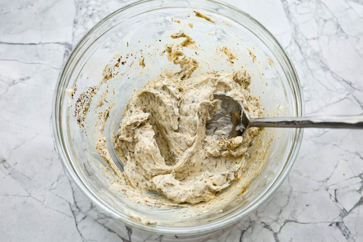 Look no further! This roasted turkey recipe is the absolute juiciest, fool-proof turkey recipe you will ever need. You'll have the confidence to make a perfect turkey every time. This deliciously seasoned turkey will be the star of your Thanksgiving meal! Sixth photo of the herb butter mixed.