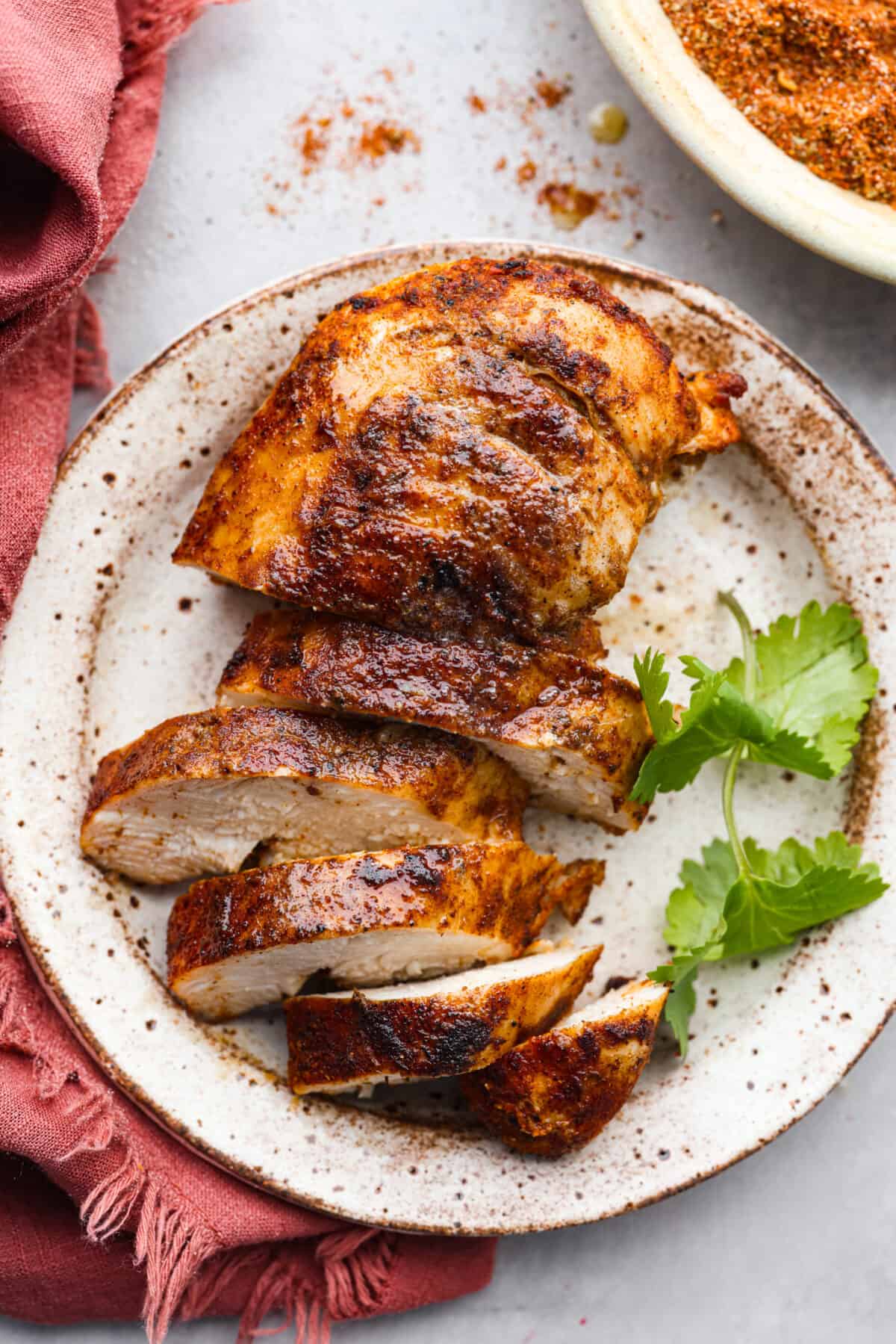 Enjoy the flavors of the Southwestern states in this tasty southwest seasoning! This homemade seasoning uses classic spices used in Southwestern cuisine. It's delicious on chicken, in tacos, or added flavoring in many dishes. Close view of sliced and seasoned chicken on a plate.