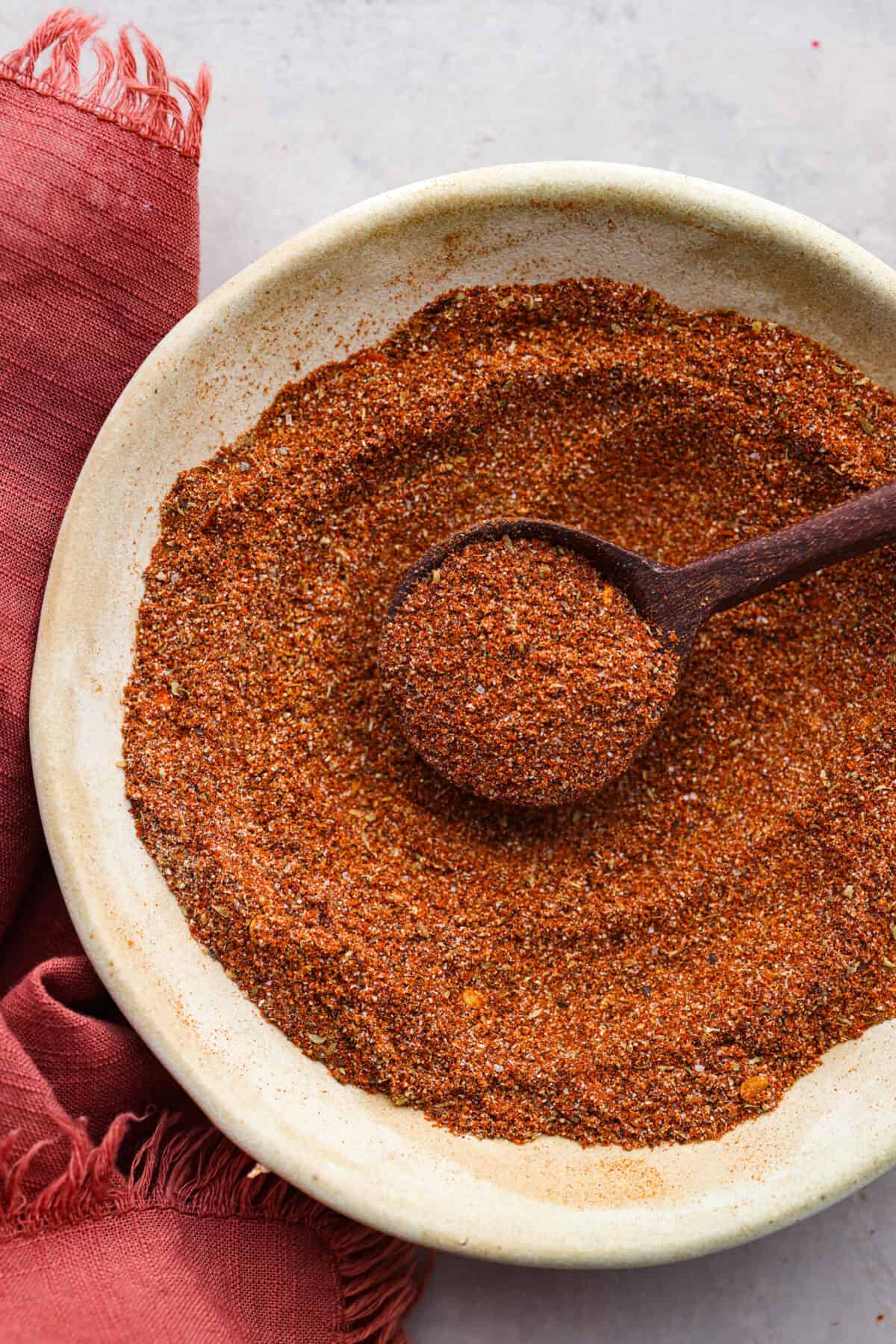Enjoy the flavors of the Southwestern states in this tasty southwest seasoning! This homemade seasoning uses classic spices used in Southwestern cuisine. It's delicious on chicken, in tacos, or added flavoring in many dishes. Close overhead view of Southwest seasoning mixed in a bowl with a wood spoon.