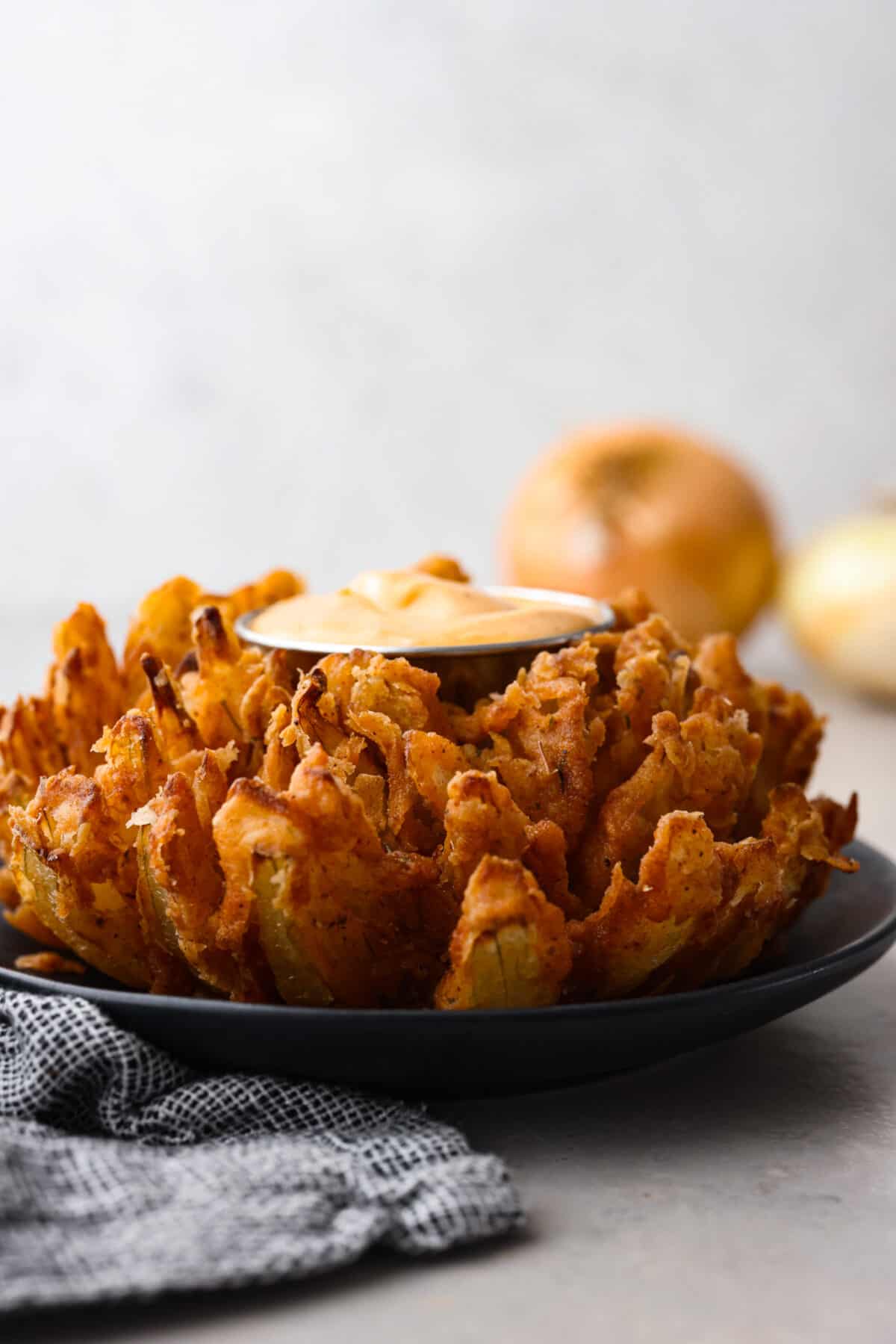 The best of the best when it comes to appetizers, this crispy bloomin' onion is the best addition to any meal. Each onion is coated in a seasoned buttermilk breading that will have you reaching for another piece. A bloomin onion served with a creamy dipping sauce.
